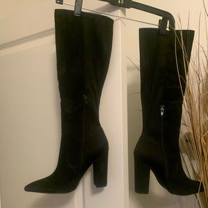 Black heeled textile boots has small unnoticeable scratch on inner right boot